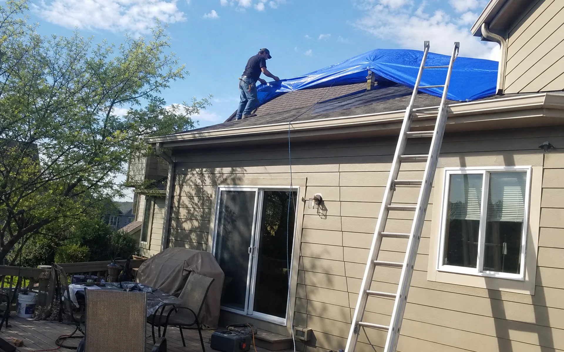Emergency roof tarping after hail damage in Castle Rock