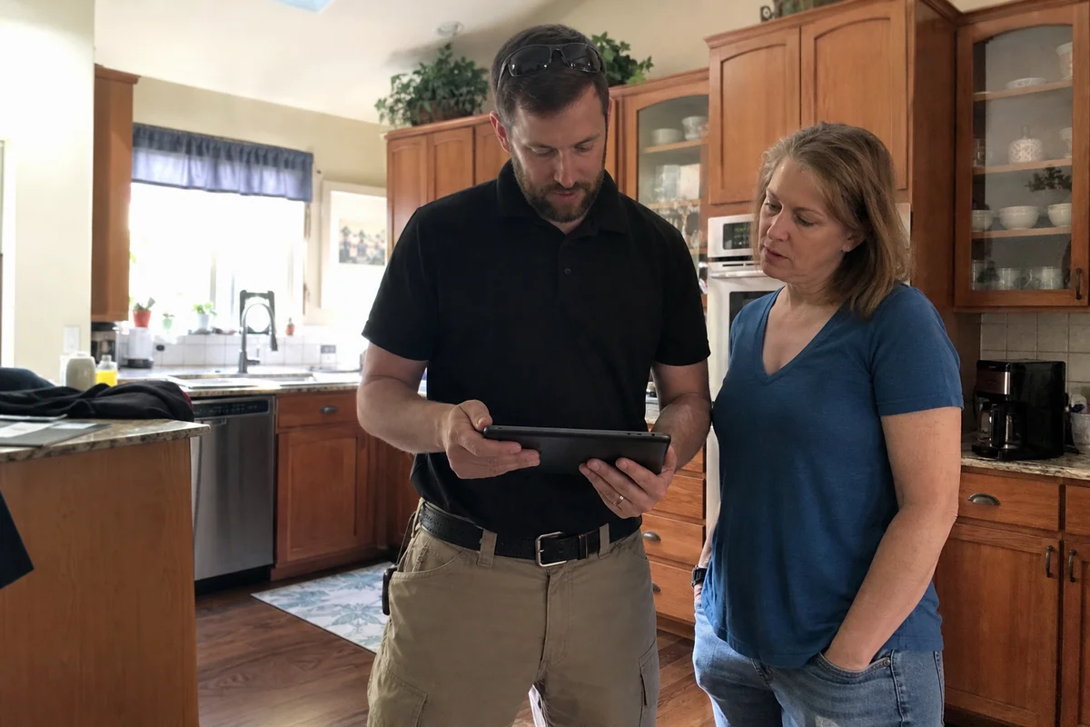 Estimator reviewing damage assessment with homeowner