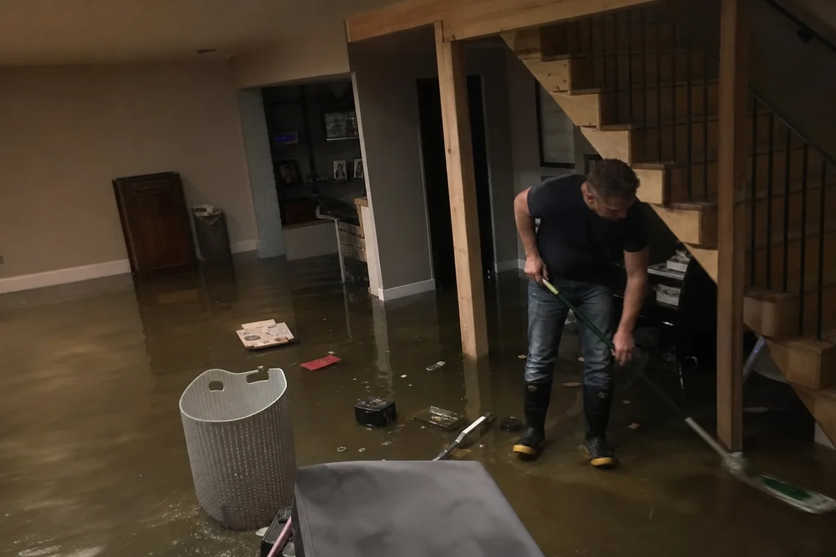 Finished basement with standing water and floating items