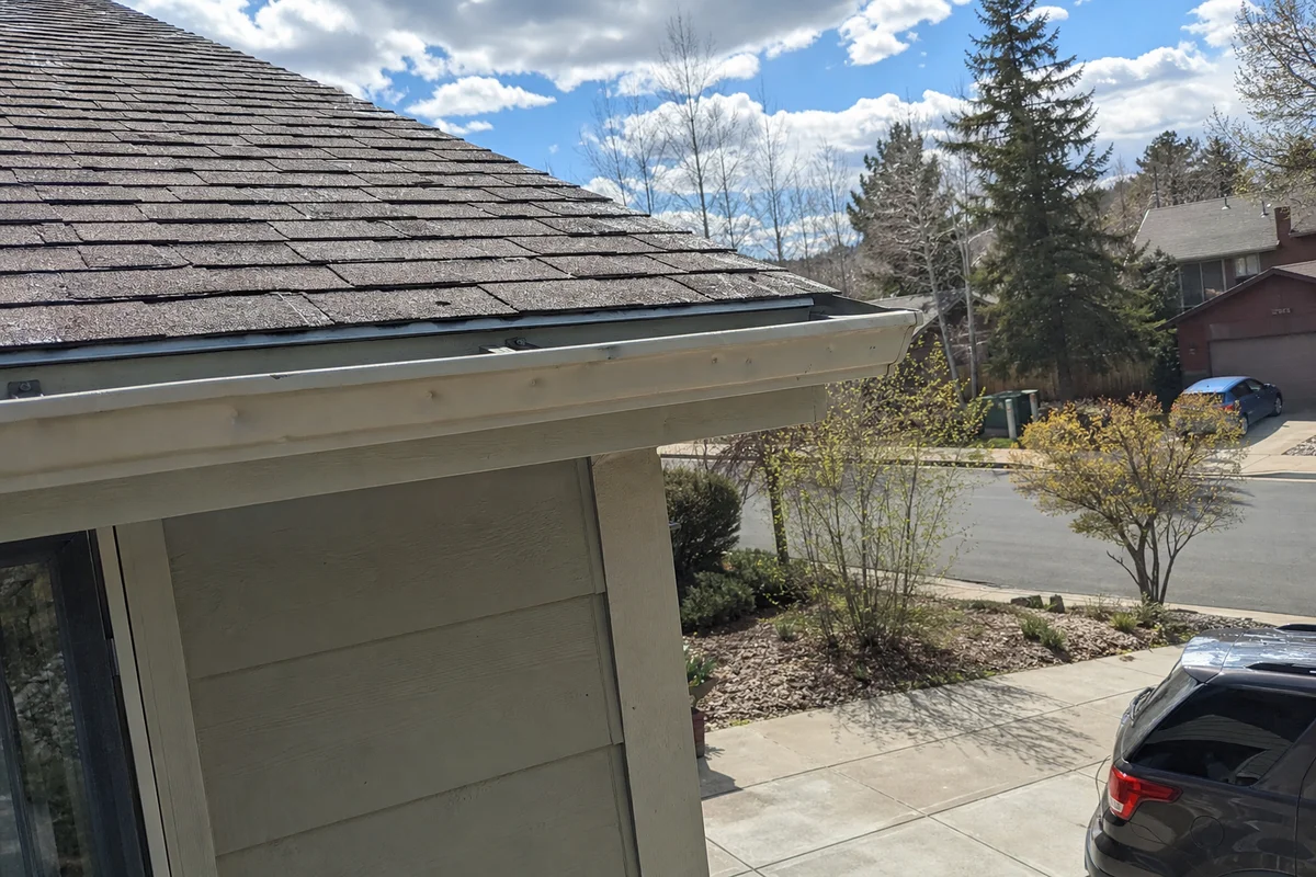 Hail dents on roof and gutter of a Colorado home